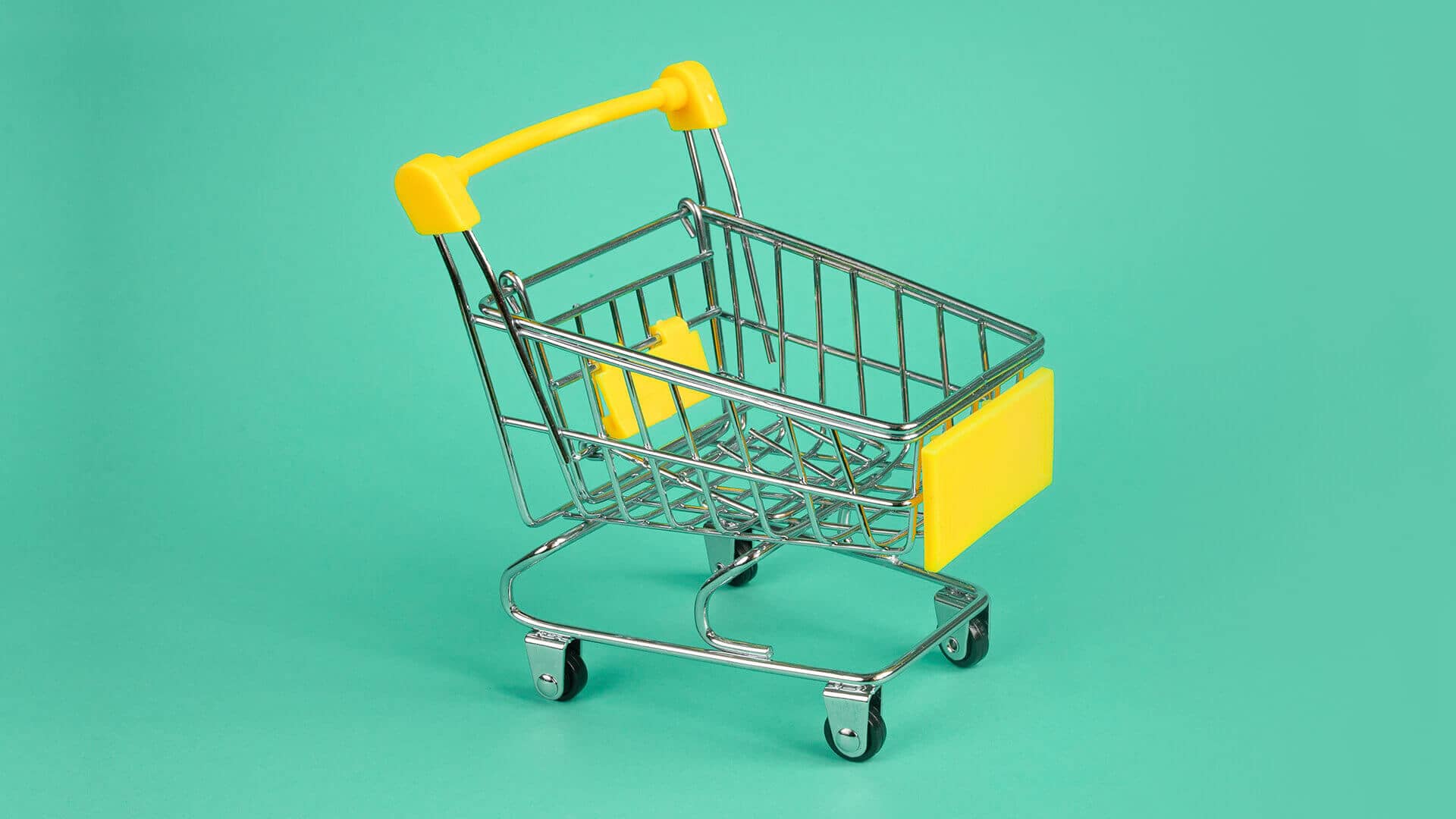 A shopping trolley on a green background
